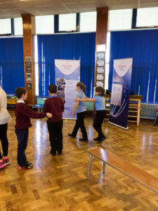 Pupils at Ysgol Llanfawr direct each other around an obstacle course