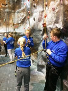 Blue Skies students from Holyhead High School belay at Indefatigable climbing wall