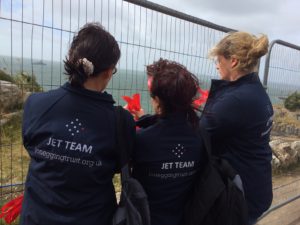 Members of the JET team gather to tie their ribbons