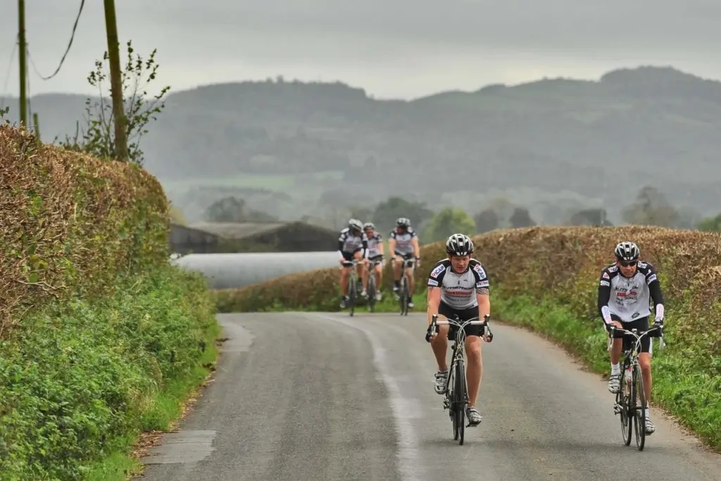 A group of bike riders on a countryside road